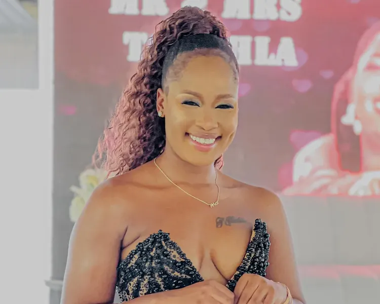 Nthabi smiling at a wedding reception