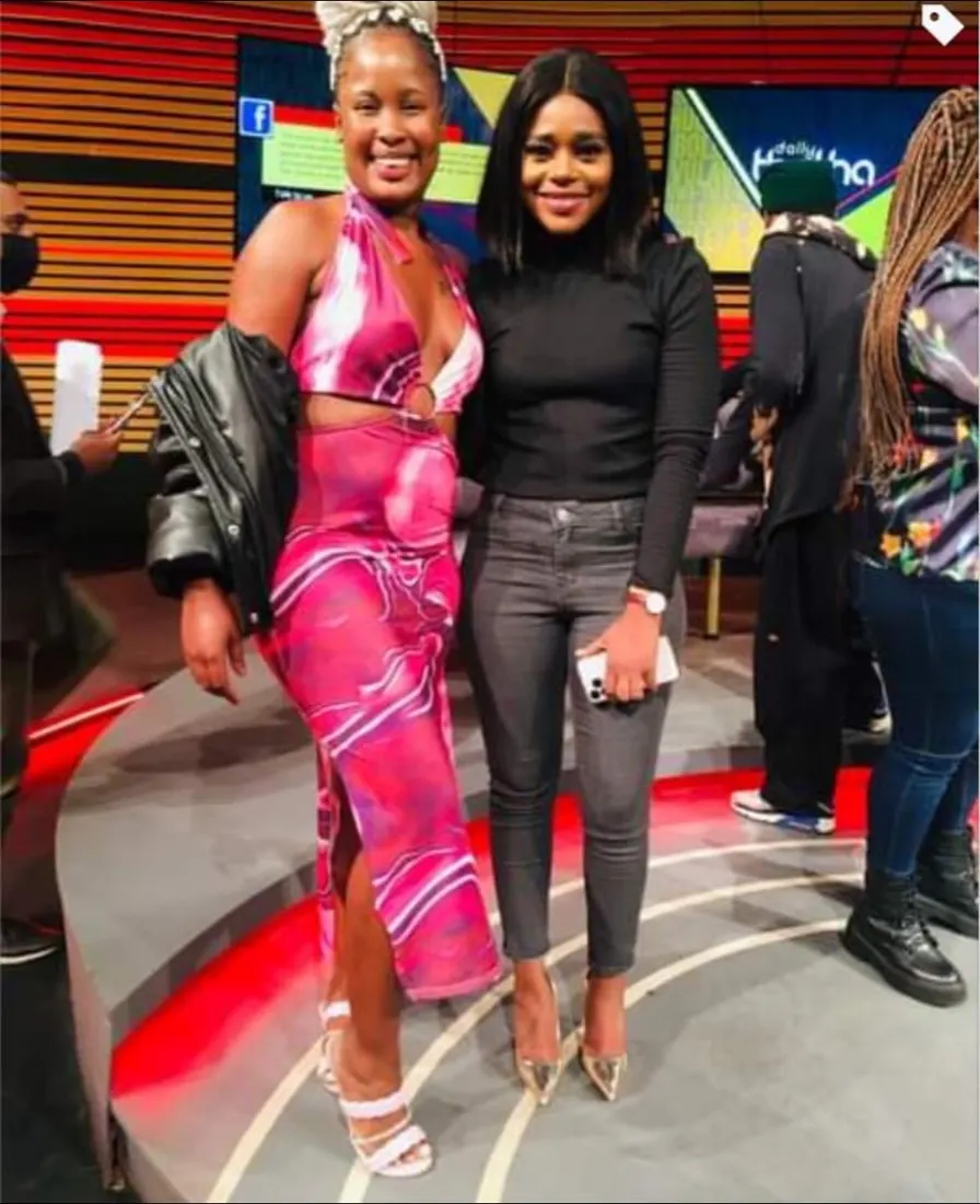 Nthabi on a television set in a pink and black outfit with a guest